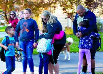 April and Rubin Doster, along with their 11-year-old daughter Mya, second from left, greet their other children, from left: Derek, 5, Savannah, 8 and Hailey, 7, after they get off of the school bus in their Palmyra neighborhood on Tuesday, Nov. 5, 2019.